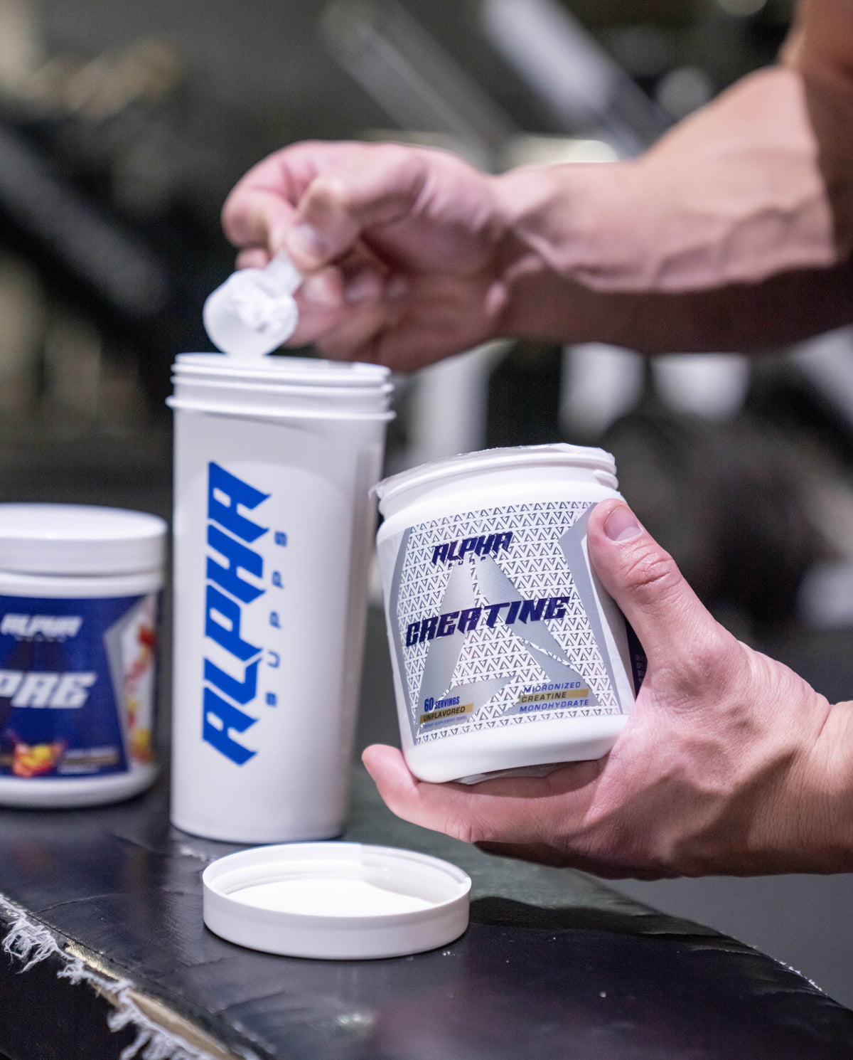 Scooping Alpha Creatine into a shaker